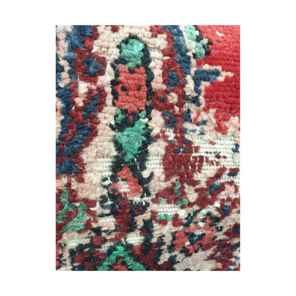 Detailed close-up of layered ivory, navy, green and red Persian motif fragments
