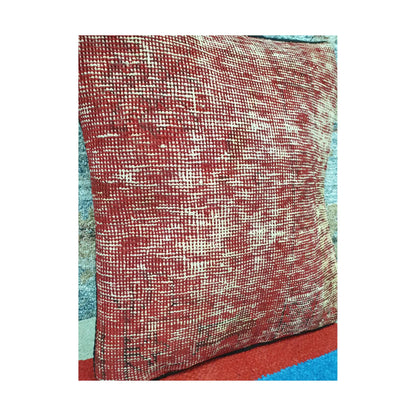 Angled view of warm red wool pile covered with irregular ivory linear traces