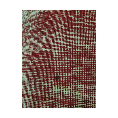 Close-up of dense ivory rectilinear lines against the muted-red wool surface