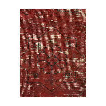 Close-up of dark floral medallion outlines across the red and ivory overdyed wool pile