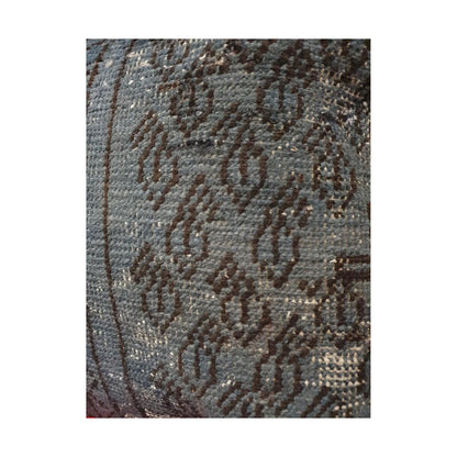 Close-up of dark brown floral motifs and softened pattern across the slate blue Persian cushion cover