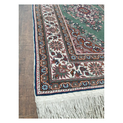 Border and fringe detail of a vintage Persian Tabriz fine rug showing floral motifs and hand-knotted wool texture
