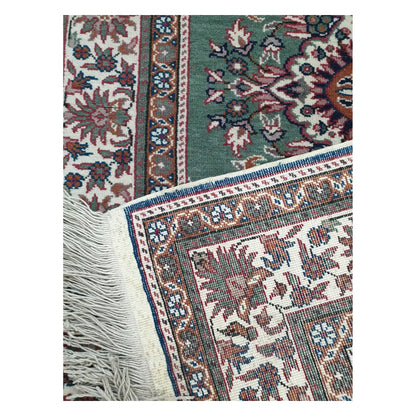 Reverse and fringe detail of a vintage Persian Tabriz fine rug showing weave structure and border pattern