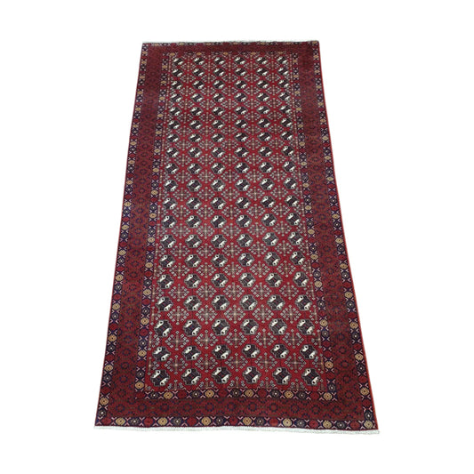 Angled full view of vintage Persian Turkoman wool rug with repeating gul-style motifs