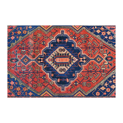 Field detail of Persian Zanjan rug showing a stepped central medallion, angular floral forms and navy corner spandrels
