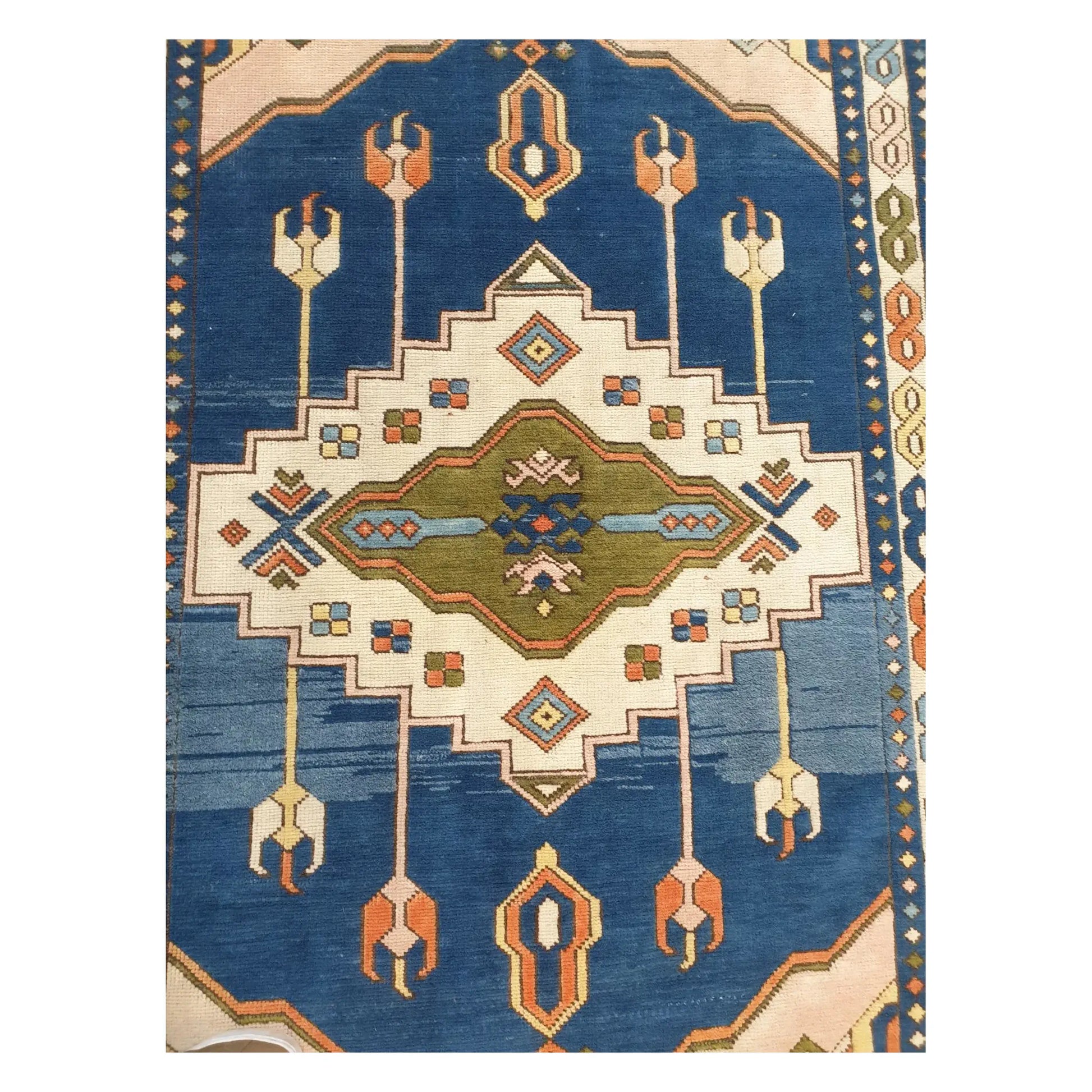 Close detail of the geometric pattern and colour variation in a vintage Turkish Anatolian wool rug