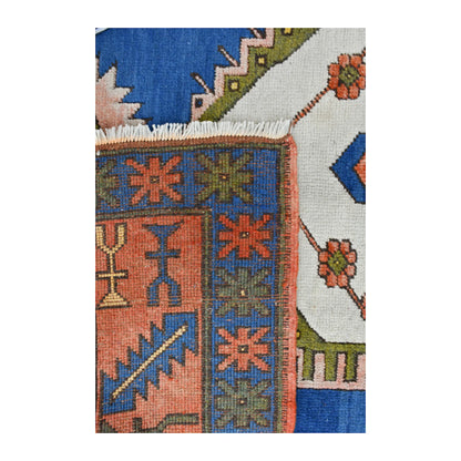 Folded-corner detail of Turkish Anatolian rug showing the reverse weave, colourful border and pale fringe