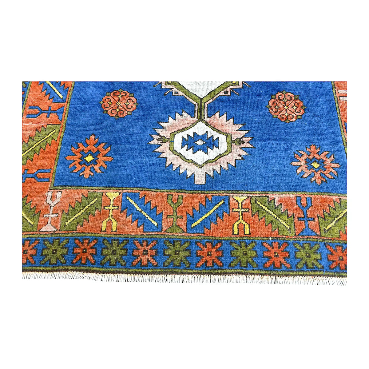 Fringe and end-border detail of Turkish Anatolian rug with olive, coral, orange and navy geometric motifs