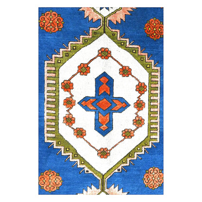 Central medallion close-up of Anatolian wool rug with ivory ground, red and navy geometric emblem and small floral motifs