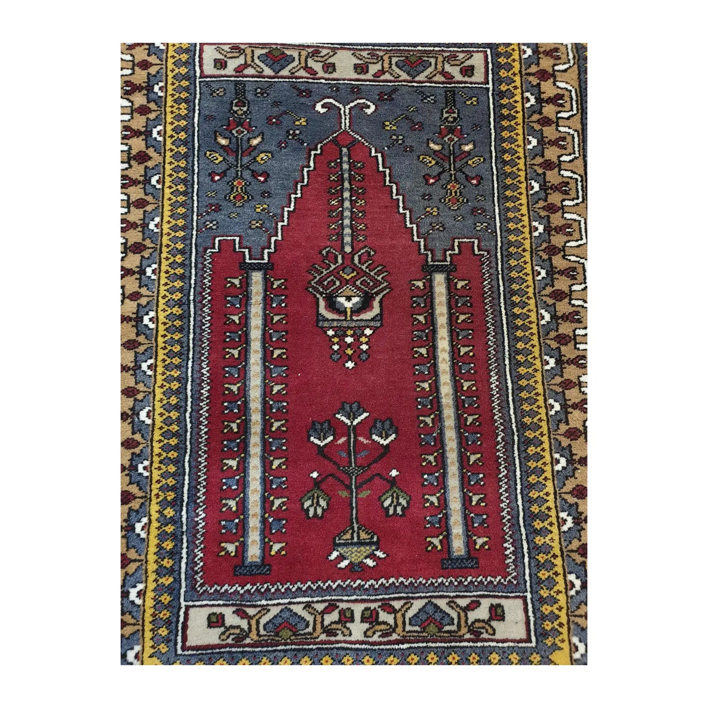 Close view of the central field of a vintage Turkish Kula rug with red niche motif and stylised floral details