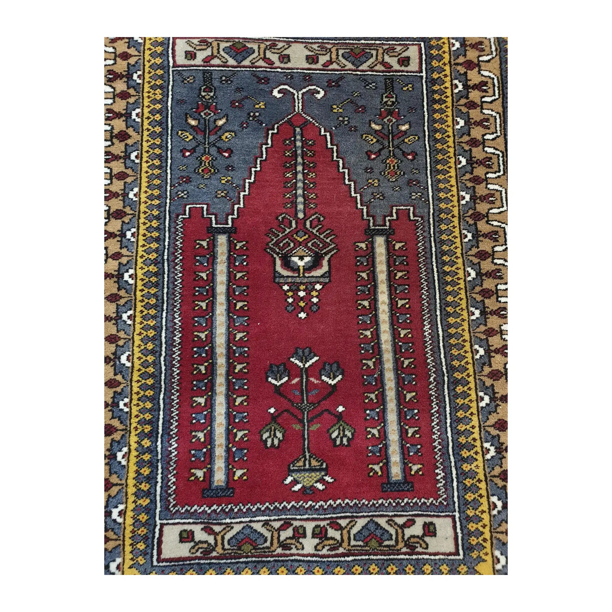 Close view of the central field of a vintage Turkish Kula rug with red niche motif and stylised floral details