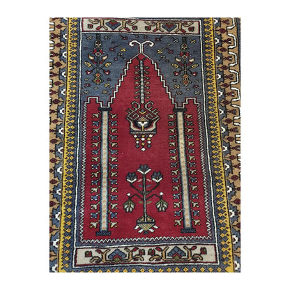 Close view of the central field of a vintage Turkish Kula rug with red niche motif and stylised floral details