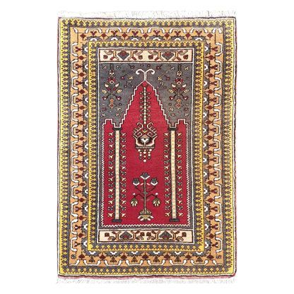 Full view of a vintage Turkish Kula hand-knotted wool rug in red with a niche design, 122 x 82 cm