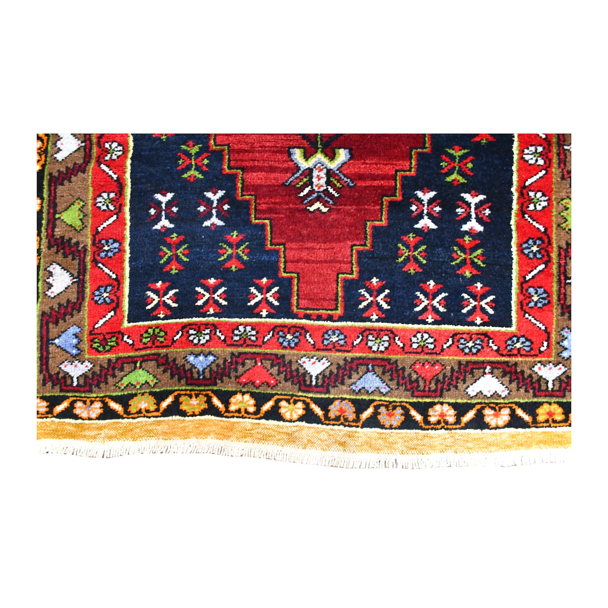 Fringe and end-border detail of Yahyali rug with stepped navy corner, colourful geometric motifs and white fringe