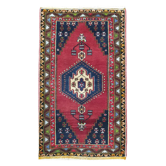 Full view of vintage Turkish Yahyali hand-knotted wool rug 232 x 120 cm with red field and central medallion