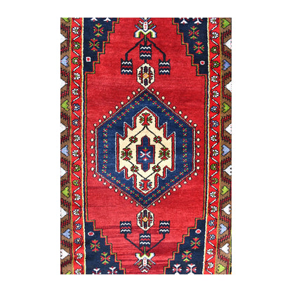 Field detail of vintage Turkish Yahyali rug showing the navy diamond medallion, red ground and smaller geometric motifs