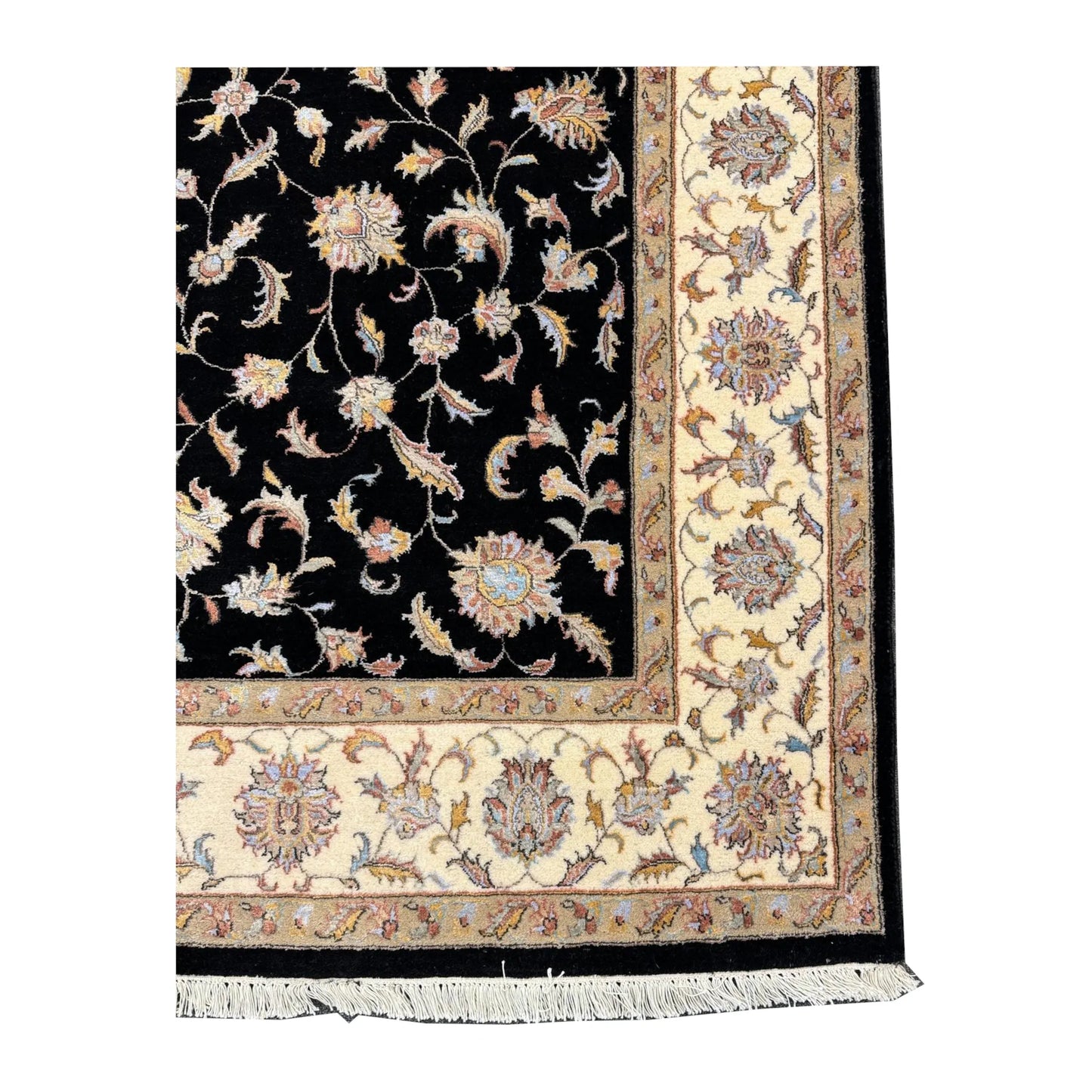 Corner detail of black Ziegler rug showing the beige floral border and fringe