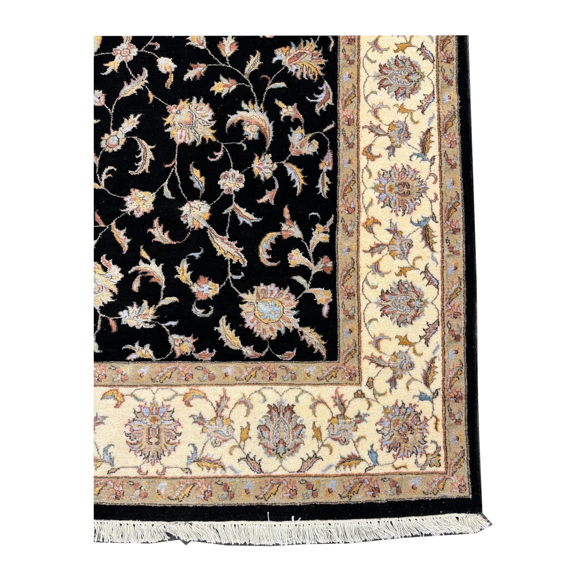 Corner detail of black Ziegler rug showing the beige floral border and fringe
