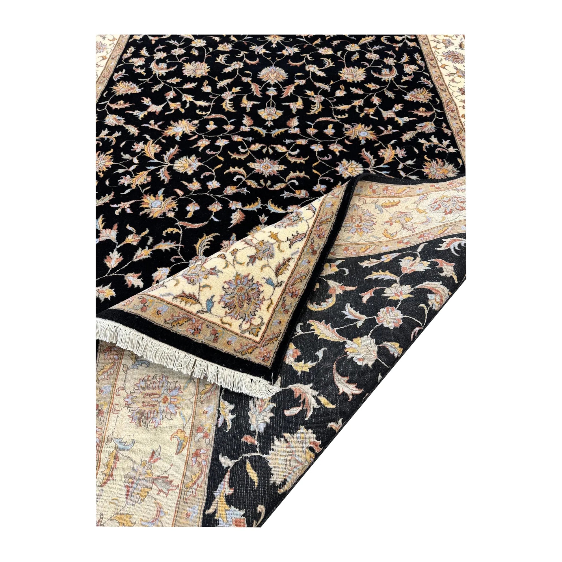 Folded corner detail of black Ziegler rug showing the surface pattern, fringe and reverse weave