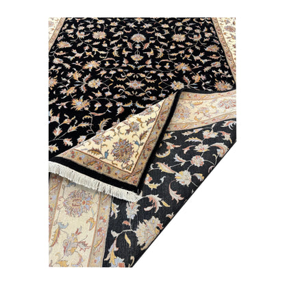 Folded corner detail of black Ziegler rug showing the surface pattern, fringe and reverse weave